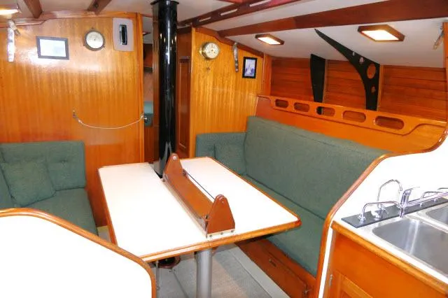 Slide: The Image of Interior of 1971 Ericson 39 Flush Deck sailboat with wood paneling and green seating. - 15