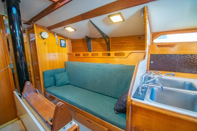 Slide: The Image of 1971 Ericson 39 Flush Deck yacht interior with wooden finish and cozy seating area. - 19