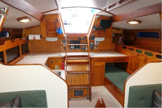 Slide: The Image of Interior of a 1971 Ericson 39 Flush Deck sailboat with wooden cabinetry and seating. - 23