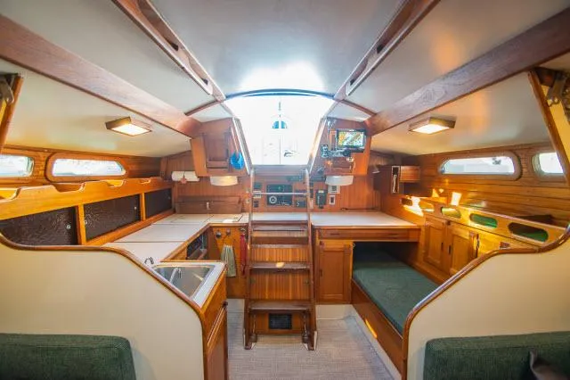 Slide: The Image of Interior of 1971 Ericson 39 Flush Deck sailboat, featuring wood finishes and cozy seating. - 24