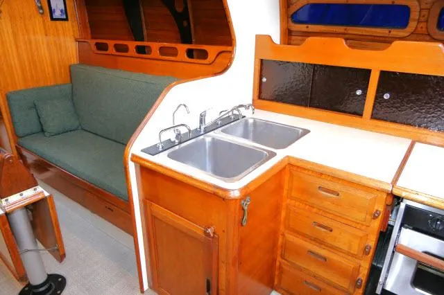 Slide: The Image of Interior of 1971 Ericson 39 Flush Deck sailboat with wooden cabinetry and dual sinks. - 25