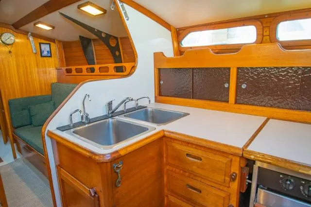 Slide: The Image of 1971 Ericson 39 Flush Deck yacht interior with wooden cabinetry and dual sinks. - 26