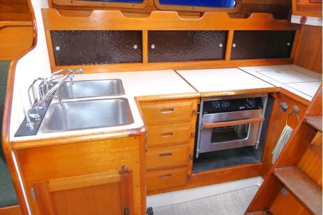 Slide: The Image of 1971 Ericson 39 Flush Deck yacht kitchen with dual sinks and stove. - 29