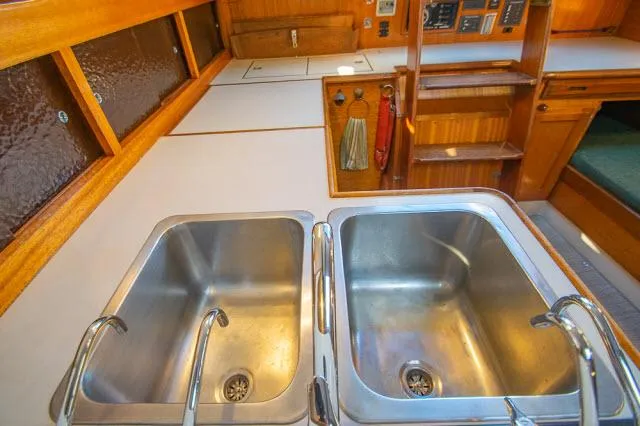 Slide: The Image of 1971 Ericson 39 Flush Deck yacht kitchen with dual stainless steel sinks. - 30