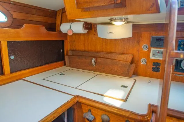 Slide: The Image of Interior of 1971 Ericson 39 Flush Deck sailboat with wooden cabinetry and white countertops. - 32