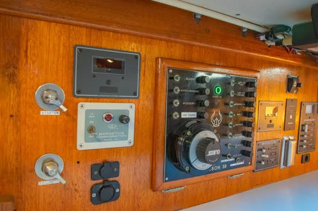 Slide: The Image of Control panel of a 1971 Ericson 39 Flush Deck sailboat, featuring various switches and gauges. - 40