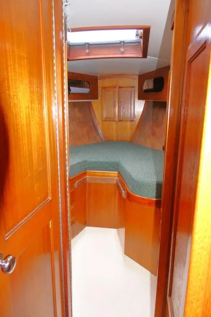 Slide: The Image of Interior of 1971 Ericson 39 Flush Deck sailboat with wooden cabinetry and cozy sleeping area. - 44