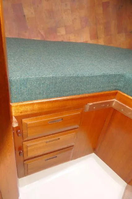 Slide: The Image of Wooden cabin interior with green cushioned bed, Ericson 39 Flush Deck, 1971 model. - 47