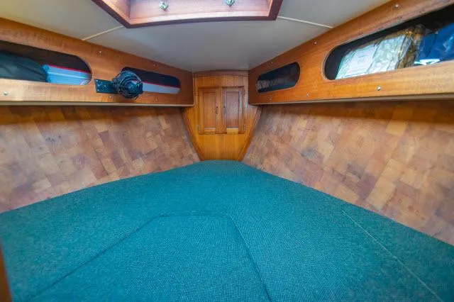 Slide: The Image of Interior cabin of 1971 Ericson 39 Flush Deck sailboat, featuring wood paneling and blue upholstery. - 48