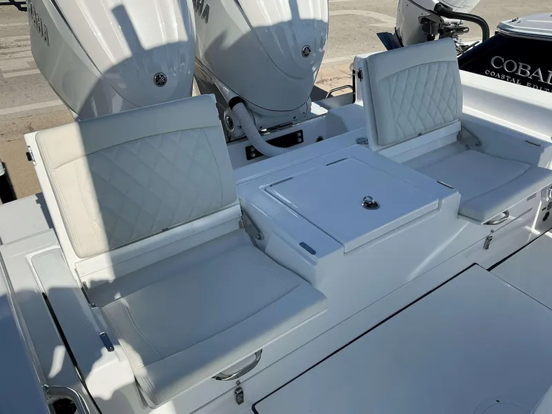 Slide: The Image of 2025 Everglades 273 CC boat with white seating and dual outboard engines. - 14