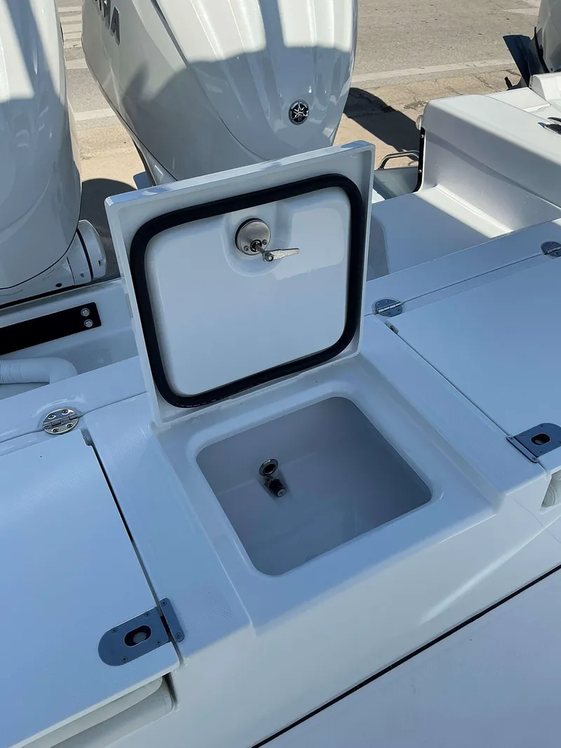 Slide: The Image of 2025 Everglades 273 CC boat with open storage compartment and dual engines. - 17