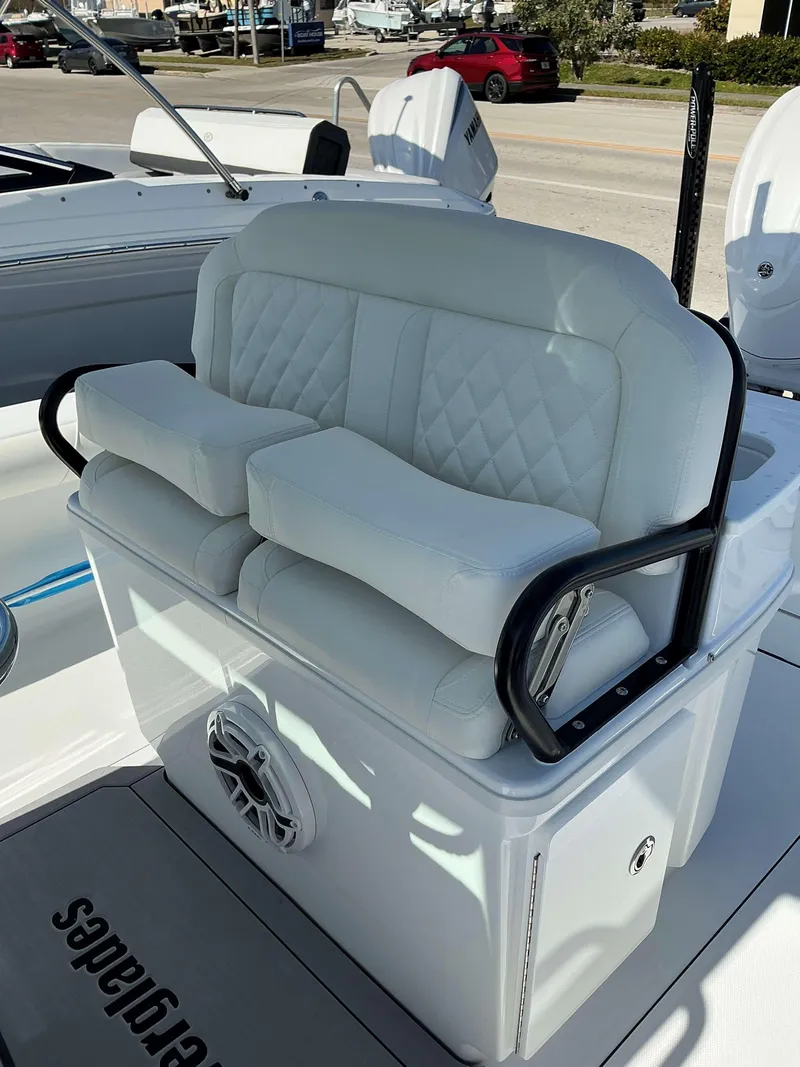 Slide: The Image of 2025 Everglades 273 CC boat seating with white cushioned seats and black armrests. - 18
