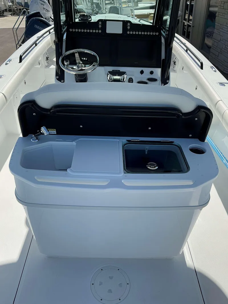 Slide: The Image of 2025 Everglades 273 CC boat interior with steering wheel and sink. - 21