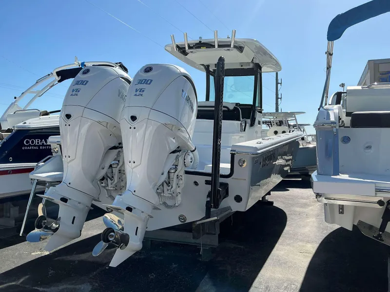 Slide: The Image of 2025 Everglades 273 CC boat with dual Yamaha 300 V6 engines, docked outdoors. - 4