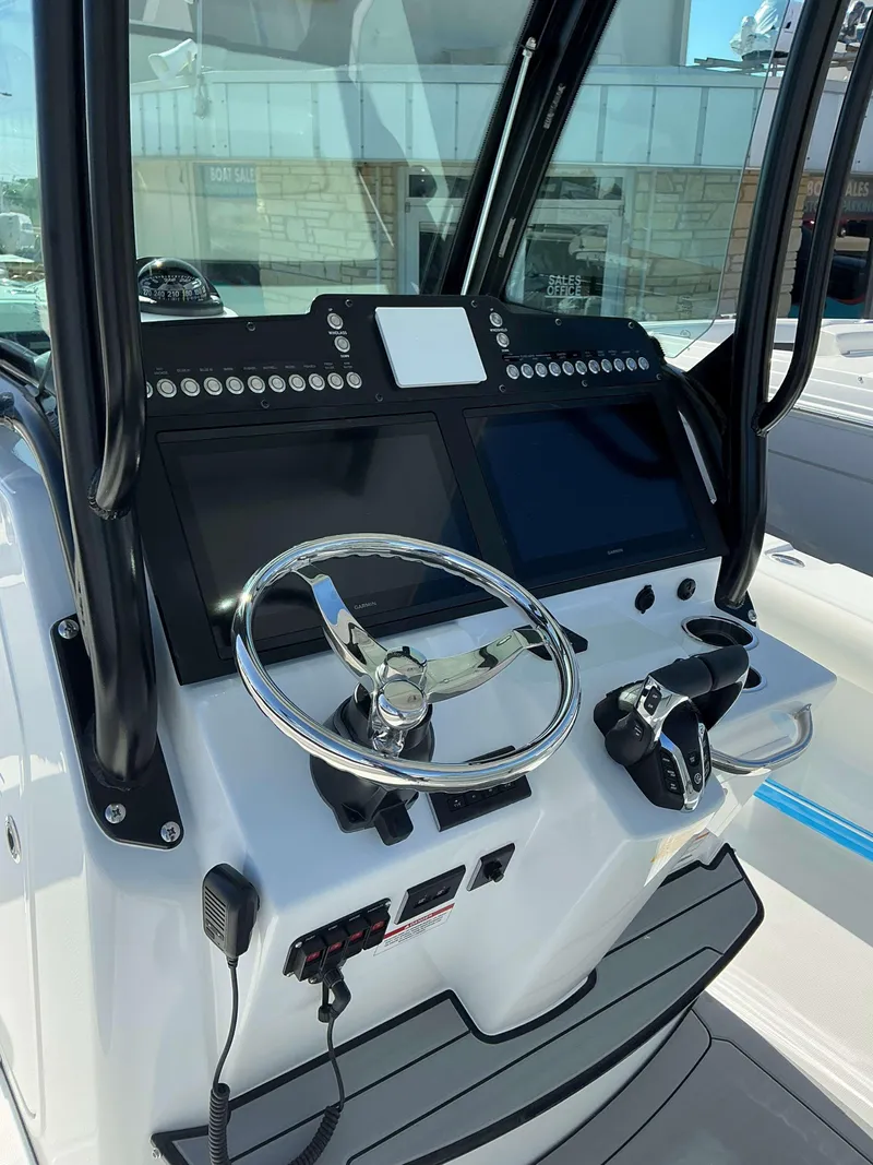 Slide: The Image of 2025 Everglades 273 CC boat dashboard with steering wheel and controls. - 6