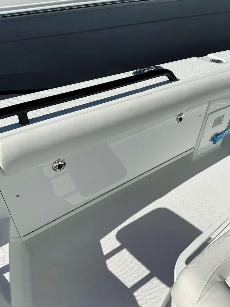 Slide: The Image of 2025 Everglades 273 CC boat interior with sleek white design and seating. - 9