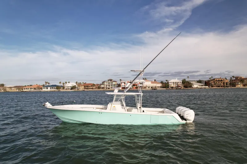 Slide: The Image of 2013 SeaVee 390B boat on water with coastal background. - 1
