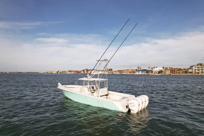 Slide: The Image of 2013 SeaVee 390B boat on calm water with clear sky background. - 2