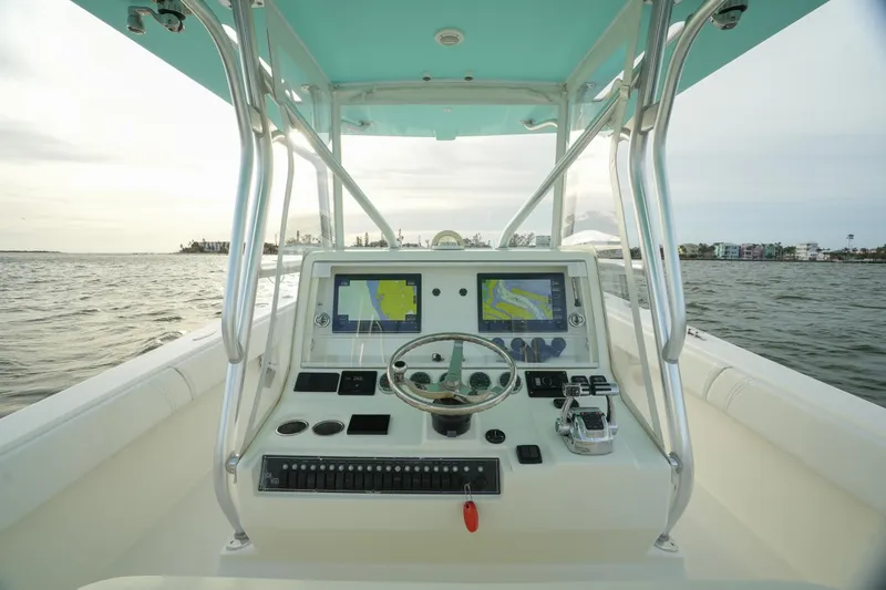 Slide: The Image of 2013 SeaVee 390B boat dashboard with navigation screens on open water. - 24