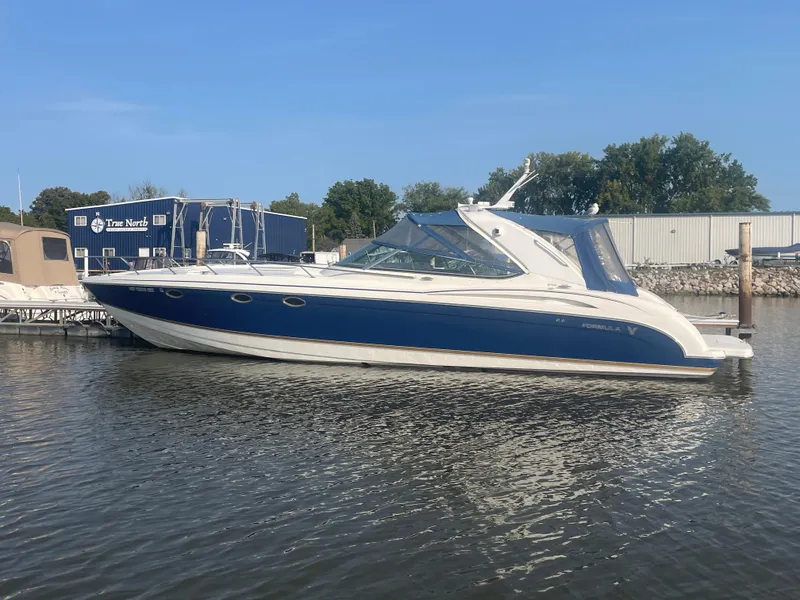 The Image of 2002 Formula 400 Super Sport boat docked on calm water. - 1
