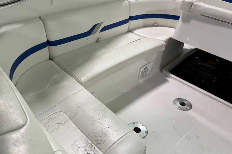 Slide: The Image of Interior seating of a 2002 Formula 400 Super Sport boat, featuring white and blue upholstery. - 15