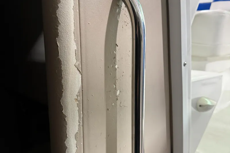 Slide: The Image of Close-up of peeling paint and metal handle on 2002 Formula 400 Super Sport boat. - 17