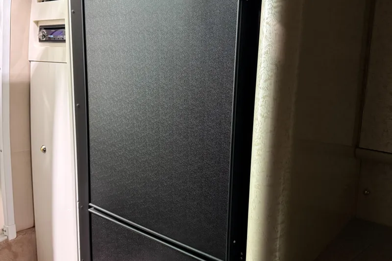 Slide: The Image of Black refrigerator inside 2002 Formula 400 Super Sport boat cabin. - 20