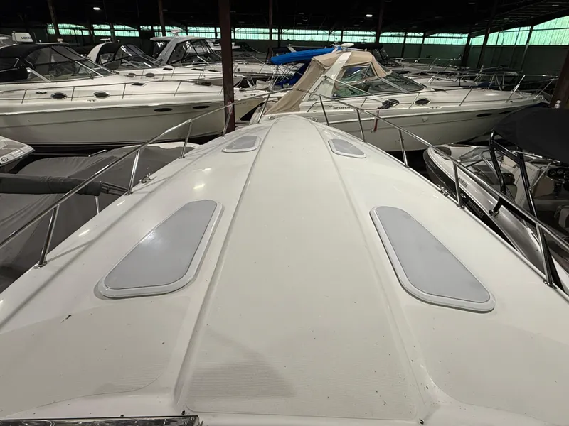 Slide: The Image of 2002 Formula 400 Super Sport boat in storage, surrounded by other vessels. - 3