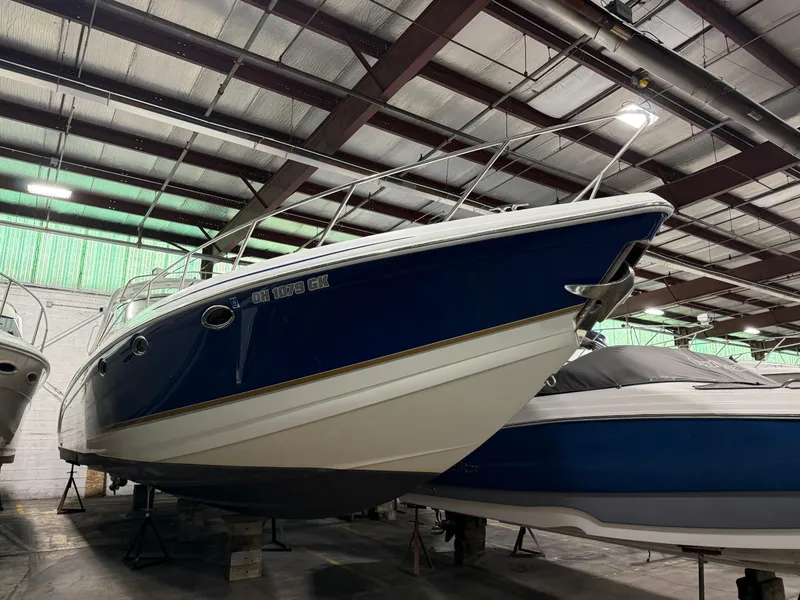Slide: The Image of 2002 Formula 400 Super Sport boat in storage, blue and white hull, indoor facility. - 5