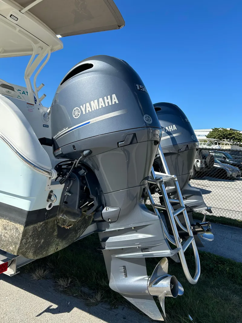 Slide: The Image of 2022 World Cat 255DC boat with dual Yamaha outboard motors, parked outdoors. - 11