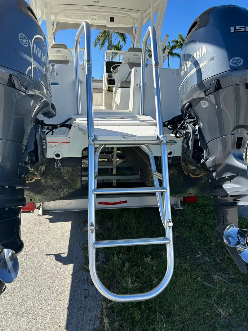 Slide: The Image of 2022 World Cat 255DC boat with dual Yamaha engines and rear ladder. - 12