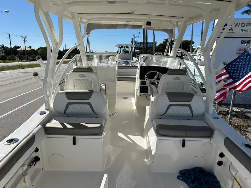 Slide: The Image of 2022 World Cat 255DC boat interior with seating and steering wheel, American flag visible. - 13