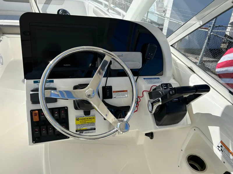 Slide: The Image of 2022 World Cat 255DC helm with steering wheel and controls. - 14