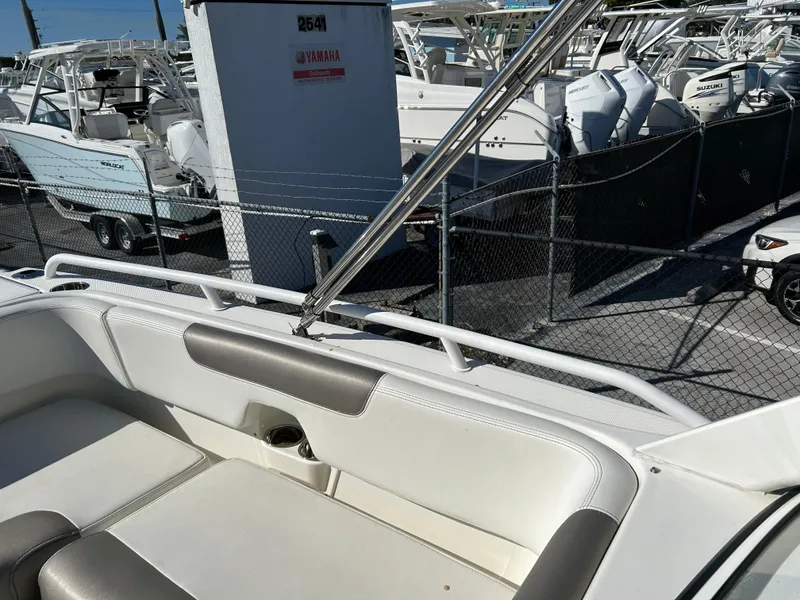 Slide: The Image of 2022 World Cat 255DC boat interior with seating, docked among other boats. - 21