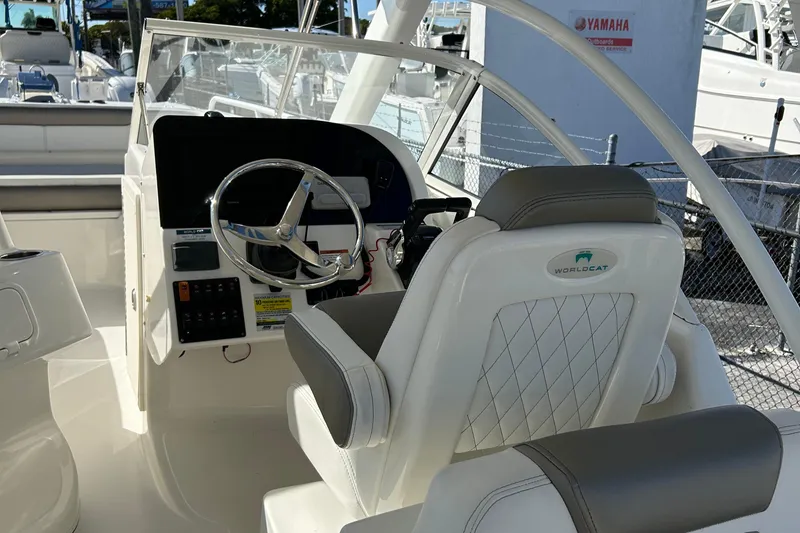 Slide: The Image of 2022 World Cat 255DC boat cockpit with steering wheel and seating. - 26