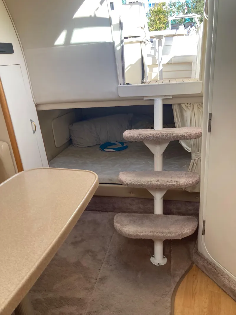 Slide: The Image of Interior of 2000 Larson Cabrio 290 boat with cozy cabin and carpeted steps. - 10