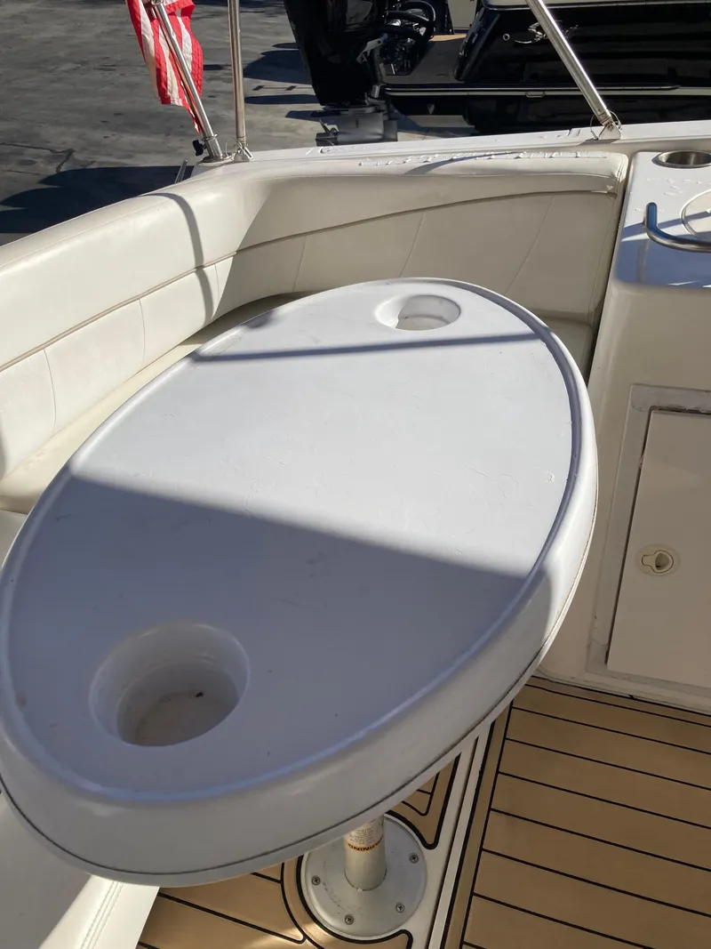Slide: The Image of Oval table on 2000 Larson Cabrio 290 boat deck with cup holders. - 15