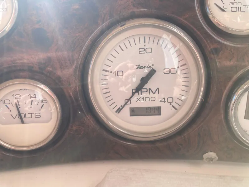 Slide: The Image of Close-up of Larson Cabrio 290 2000 boat dashboard gauges, showing RPM and voltage. - 26