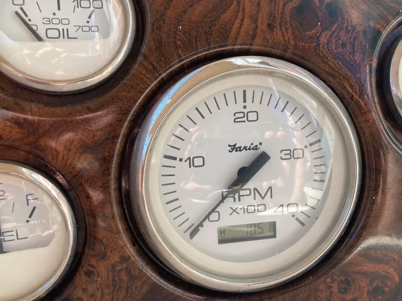 Slide: The Image of Close-up of Larson Cabrio 290 2000 boat RPM gauge on wood panel. - 27