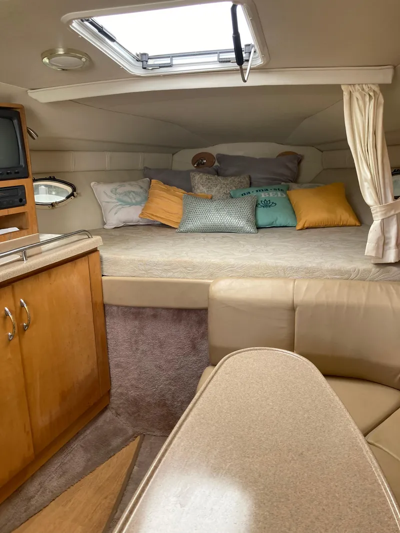 Slide: The Image of Interior of 2000 Larson Cabrio 290 boat with cozy cabin and seating area. - 7