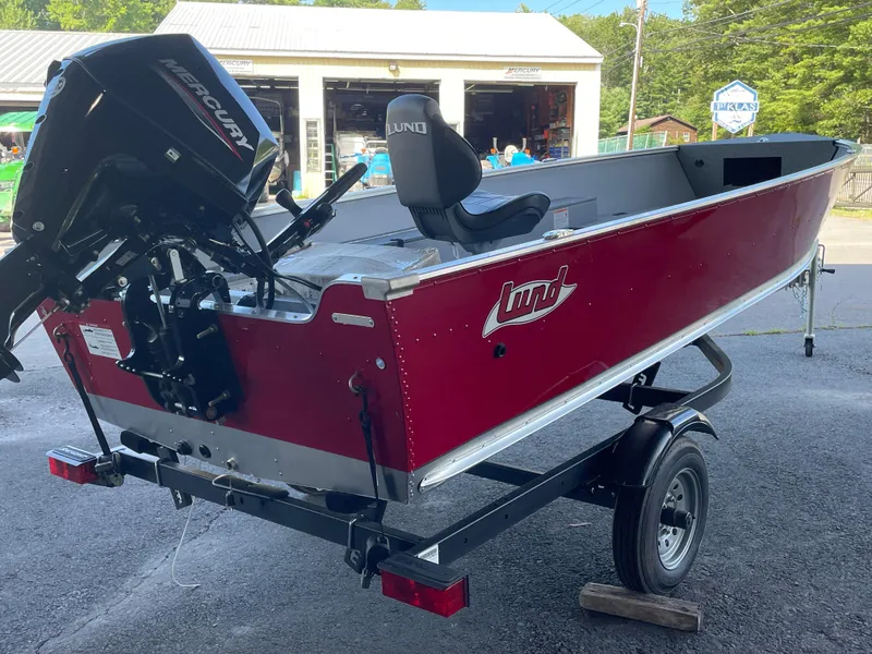 Slide: The Image of 2025 Lund 1600 Fury Tiller boat with Mercury engine on a trailer. - 2
