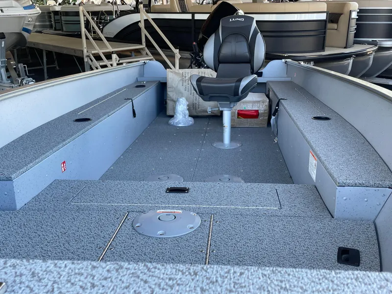 Slide: The Image of 2025 Lund 1600 Fury Tiller boat interior with seating and storage compartments. - 3