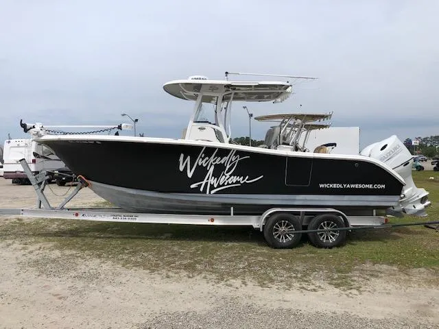 Slide: The Image of 2021 Sea Pro 259 DLX boat on trailer, "Wickedly Awesome" branding. - 0