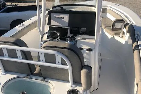 Slide: The Image of 2021 Sea Pro 259 DLX boat interior with steering console and seating. - 10
