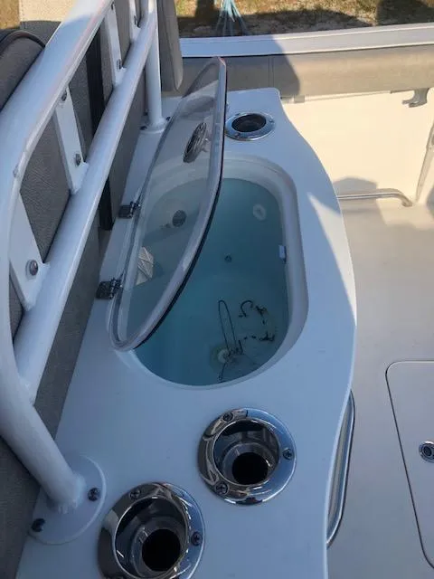 Slide: The Image of 2021 Sea Pro 259 DLX boat with open livewell and rod holders. - 12