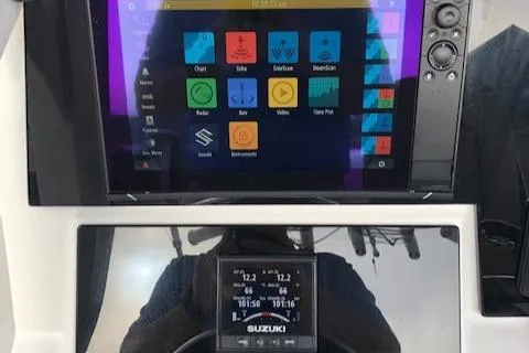 Slide: The Image of 2021 Sea Pro 259 DLX boat dashboard with advanced navigation and control systems. - 15