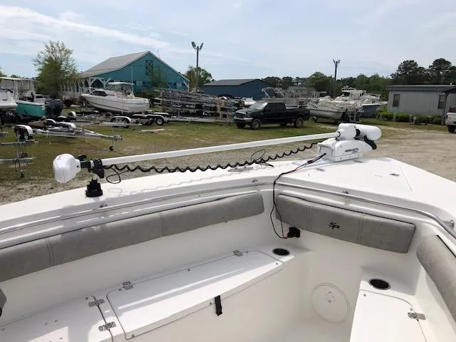 Slide: The Image of 2021 Sea Pro 259 DLX boat with trolling motor in a marina setting. - 19
