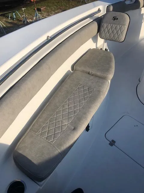 Slide: The Image of 2021 Sea Pro 259 DLX boat with cushioned seating and quilted design. - 21