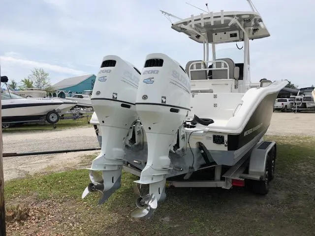Slide: The Image of 2021 Sea Pro 259 DLX boat with dual outboard engines on a trailer. - 4