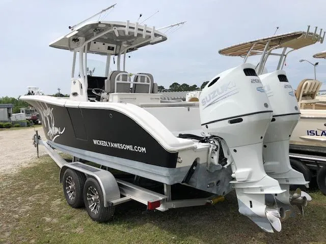 Slide: The Image of 2021 Sea Pro 259 DLX boat with dual engines on a trailer. - 6